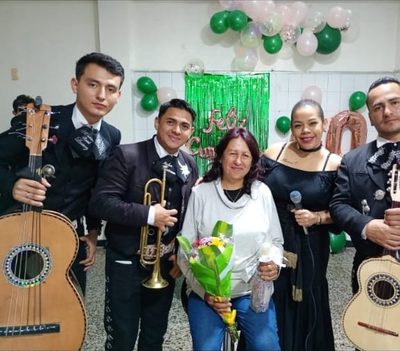 Mariachi en un cumpleaños en Bogotá junto a la homenajeada con su ramo